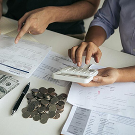 Two People Checking Some Bills