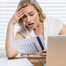 A Worried Woman Looking At Some Sheets