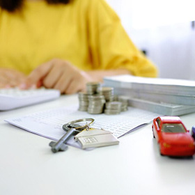 A House Key and Money on Top of a Desk